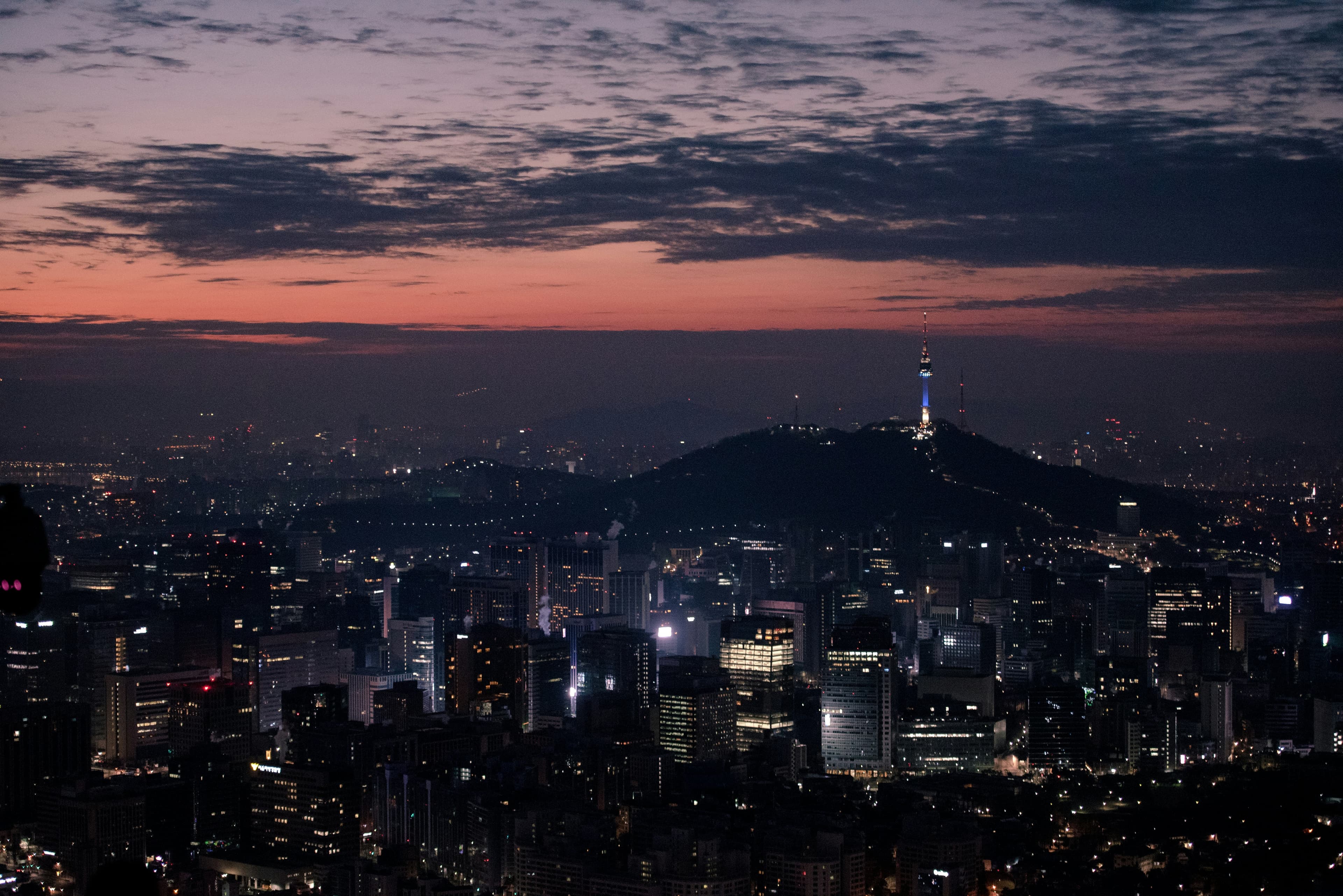 Seoul skyline and N Seoul Tower at dusk · Yohan Cho / Unsplash